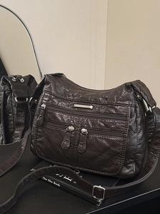 Deep brown soft leather tote bag with vintage texture and multiple zipper pockets