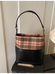 Vintage bucket bag featuring black leather and brown plaid tweed with a shoulder strap