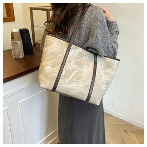 Chic beige marble pattern tote bag with dark brown straps shown in minimalist cafe setting