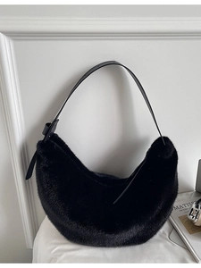 Fuzzy black plush crescent bag with adjustable strap and sleek faux fur texture