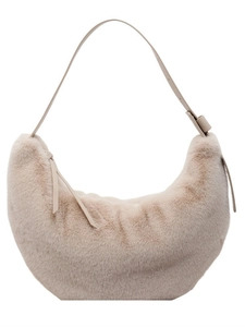 Chic beige fuzzy faux fur crescent shoulder bag with adjustable leather strap on white background