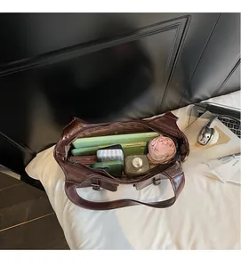 Interior view of large capacity brown leather tote bag showing organized daily essentials