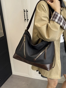 Black and brown patchwork large capacity tote bag with decorative gold zippers