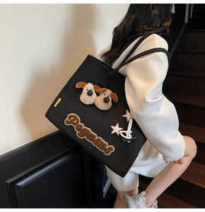 Détail du cabas en toile noire avec oreilles de chiot Gromit en peluche et patch Peanut