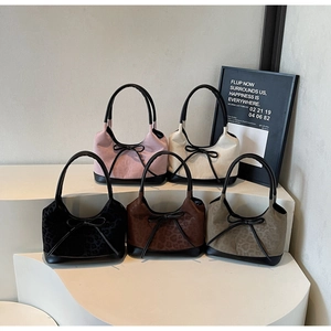 Group of leopard print suede bucket bags in five colors with black bow tie accents