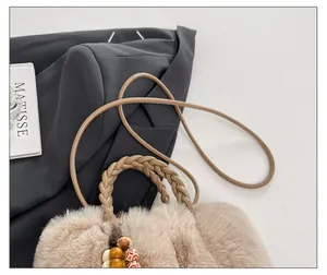 Detail der flauschigen Kunstpelz-Beuteltasche mit Webgriff und Vintage-Holzperlen
