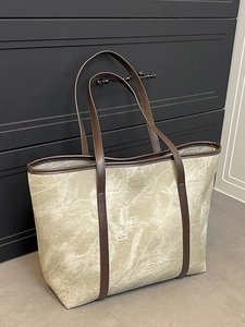 Chic beige tote bag with marble texture and dark brown handles for women daily commute