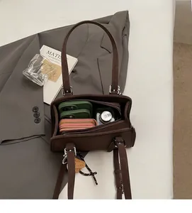 Top-down view of a spacious brown suede handbag interior showing large storage capacity