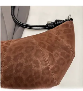 Close-up of vintage brown leopard print shoulder bag with soft faux fur texture