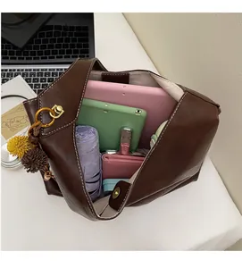 Interior view of large brown tote bag showing spacious storage for tablets and umbrellas