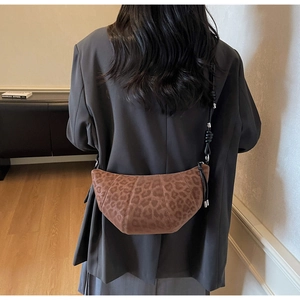 Detail of leopard print croissant bag with adjustable black leather knotted strap