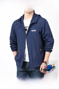 Close-up of lightweight navy blue outdoor windbreaker with hooded zipper and logo detail