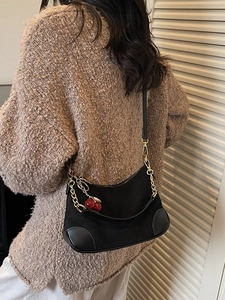 Black canvas baguette bag with gold chain, cherry charm and leather corners details