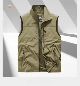 Close-up of a khaki outdoor vest featuring a mesh lining and multiple zipper pockets
