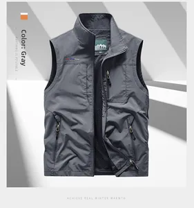 Detail of dark gray outdoor vest showing zip chest pocket and freedomway embroidery