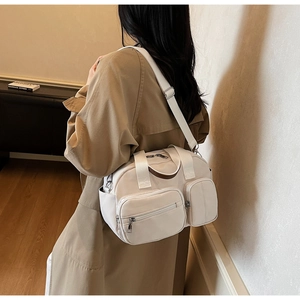 Detail of off-white multi-pocket nylon crossbody bag with adjustable wide strap