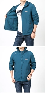 Detail of dark cyan men's sun protection jacket with outdoor logo and zip pockets