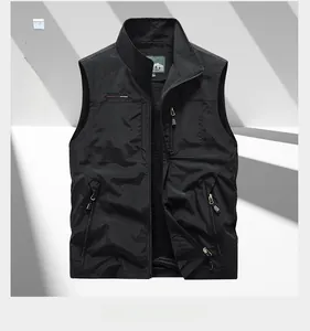 Detail of black outdoor utility vest with three zipper pockets and stand-up collar