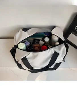 Spacious interior of off-white travel bag showing organized storage for gym and travel gear