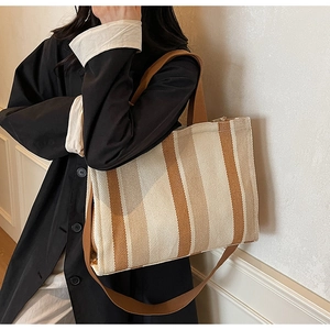 Detail of striped canvas tote bag with adjustable shoulder strap and large capacity