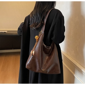 Brown faux leather hobo bag featuring retro tassel and colorful wooden bead charms