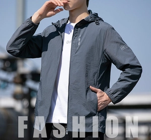 Detail of dark grey hooded sun protection jacket with zip pocket and elastic cuffs