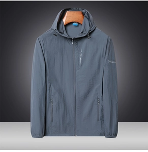 Detail of grey sun protection jacket with drawstring hood and zip pockets for men