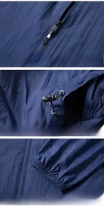 Detail view of navy blue windbreaker featuring zipper, adjustable drawstring, and elastic cuffs