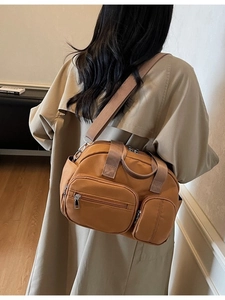 Large khaki canvas tote bag for women featuring multi-pocket design and crossbody strap