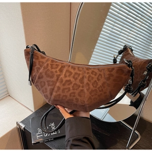 Detailed view of leopard print crescent bag with frosted texture and pleated design