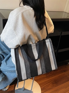 Vertical striped canvas tote bag for women showing a stylish large capacity shoulder design