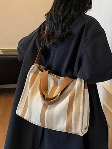 Striped canvas tote bag with large capacity and shoulder straps in a minimalist style