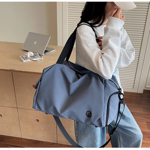 Detail view of the Morandi blue fitness travel bag showing side zipper pocket and texture