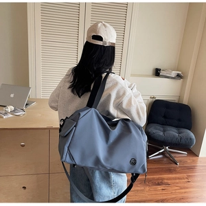 Detail of travel bag with durable fabric, side pocket and adjustable shoulder strap