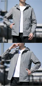 Detail of light grey sun protection jacket with elastic cuffs and zippered pocket