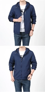 Detail view of a men's navy hooded sun protection jacket with red zip pockets