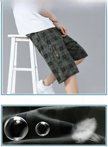Detail of dark green camo plaid shorts showing breathable cotton fabric and cargo pocket