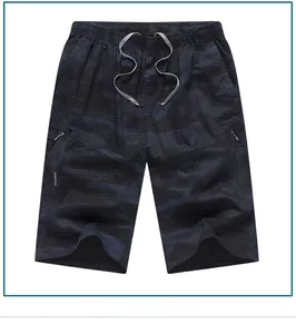 Detail of loose camouflage shorts with elastic drawstring waist and hidden zipper pockets