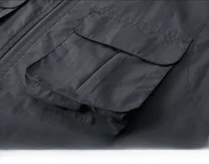 Close-up of durable cargo pocket on grey multi-pocket tactical fishing vest