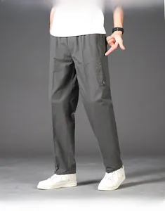 Detail of grey men's straight casual trousers showing side zipper pocket and elastic waist