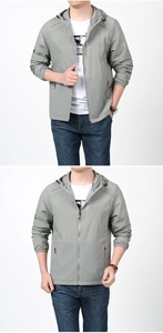 Detail of gray-green hooded sun protection jacket with zipper pocket and elastic cuffs