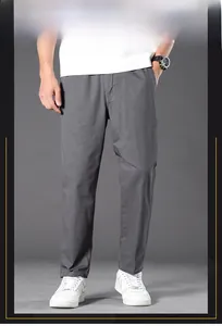 Detail of grey cotton pants with elastic waistband and straight leg fit for men