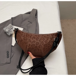 Detail shot of leopard print hobo bag with frosted texture and knotted strap