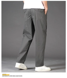 Detail of dark grey men's trousers featuring a back flap pocket and straight leg cut