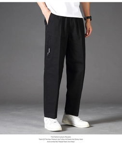 Detail view of black men's casual trousers featuring elastic waist and side zipper cargo pocket