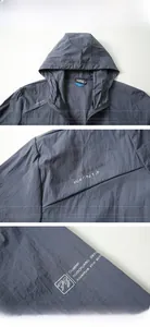 Detail view of grey-blue sun protection jacket featuring hooded design and chest printing