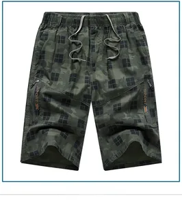 Detail of army green plaid cargo shorts featuring elastic drawstring waist and side zip pockets