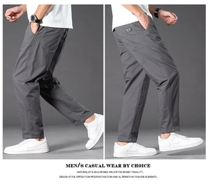 Detail of grey cotton cargo pants showing straight leg cut and back pocket branding tag