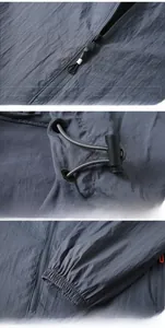 Detail view of smooth metal zipper and adjustable drawstring on a lightweight sun jacket