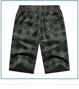 Detail of army green camo and plaid patchwork on men's cotton shorts with elastic waistband
